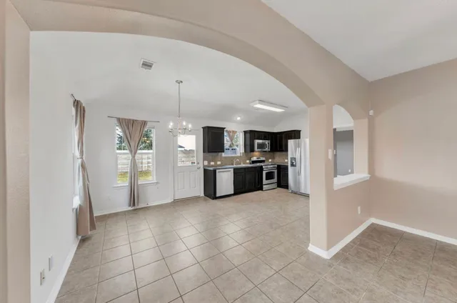 a large white kitchen with cabinets and a stainless steel appliances