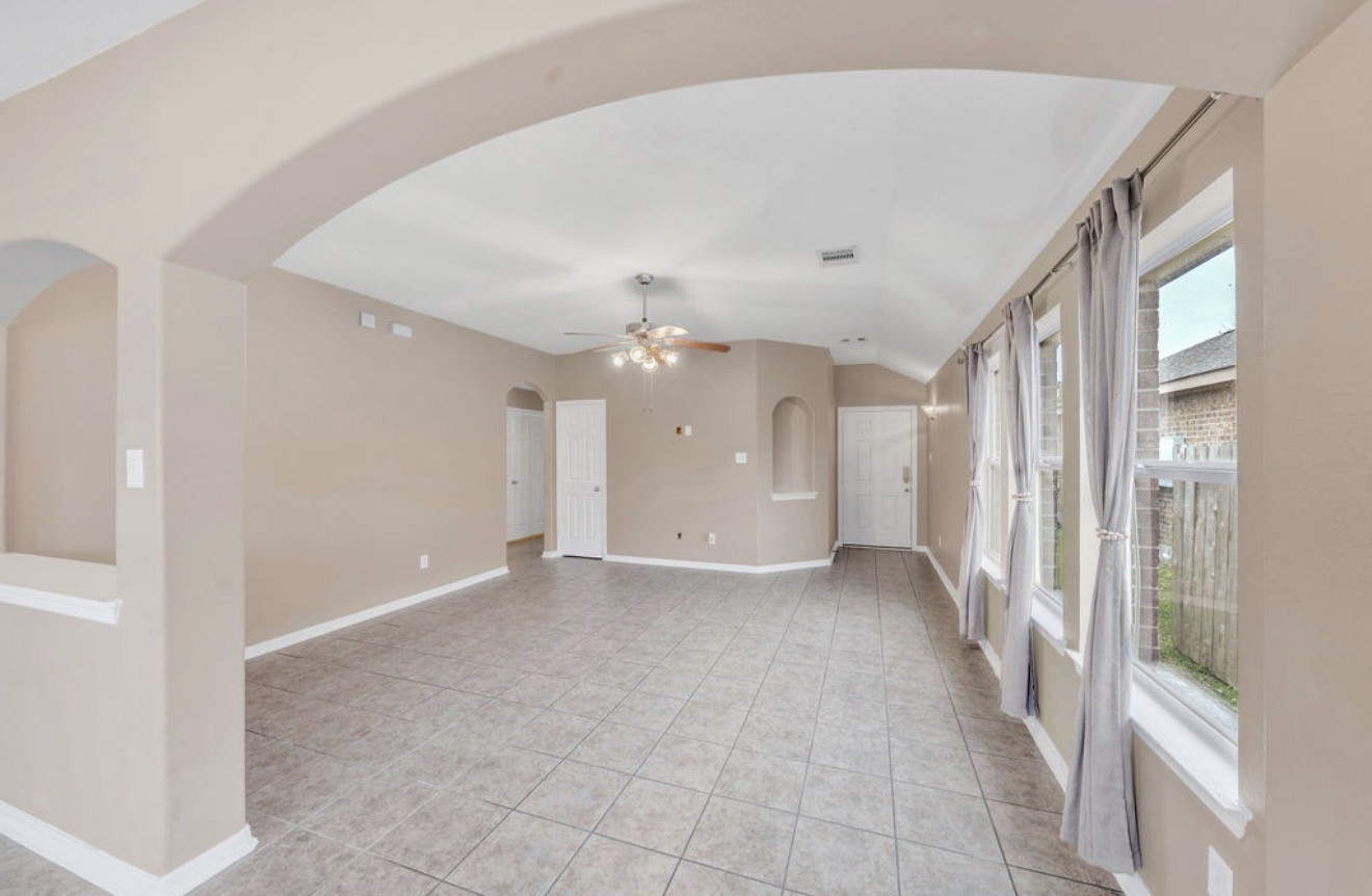 9807 Onyx Trail Drive Rosharon, TX 77583 - Photo 10 of 24 a view of a big room with a chandelier fan and windows