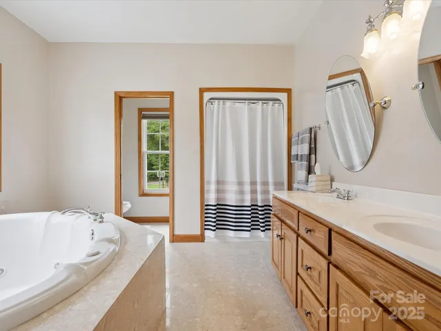 a bathroom with a bathtub a sink and a mirror