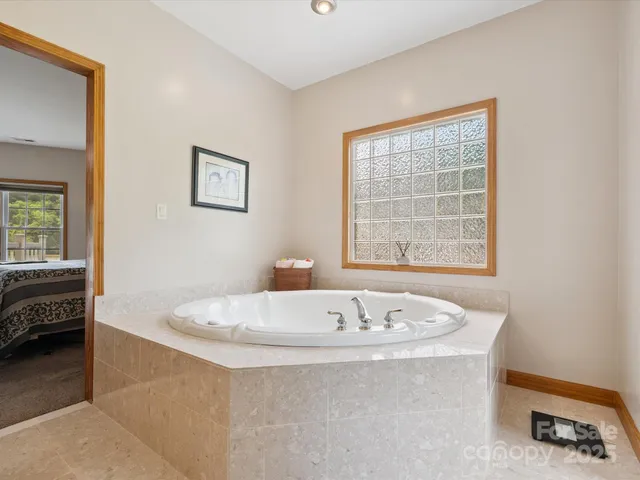a bath tub sitting in a bathroom next to a window