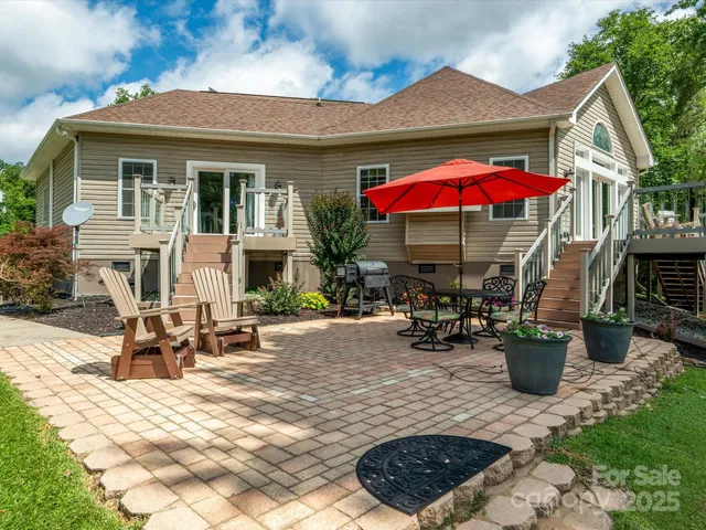 a view of a patio with table and chairs under an umbrella
