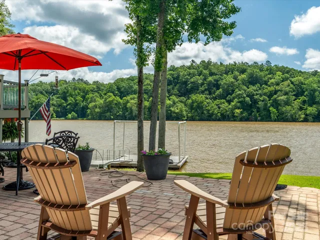 a view of an outdoor sitting area with furniture and umbrella