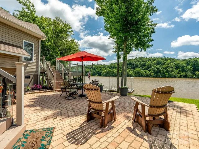 a patio with a table and chairs under an umbrella