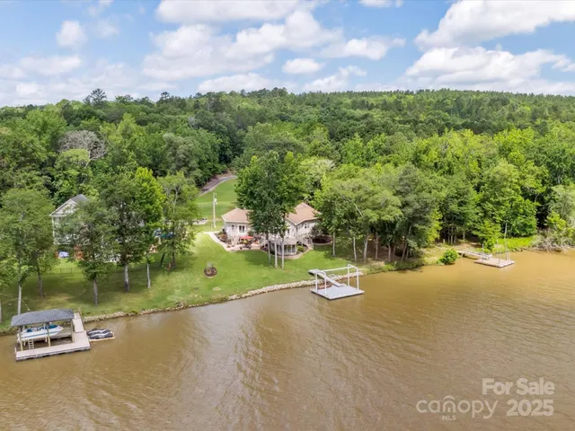 a view of a street with a yard and car parked