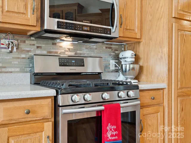 a stove top oven sitting inside of a kitchen