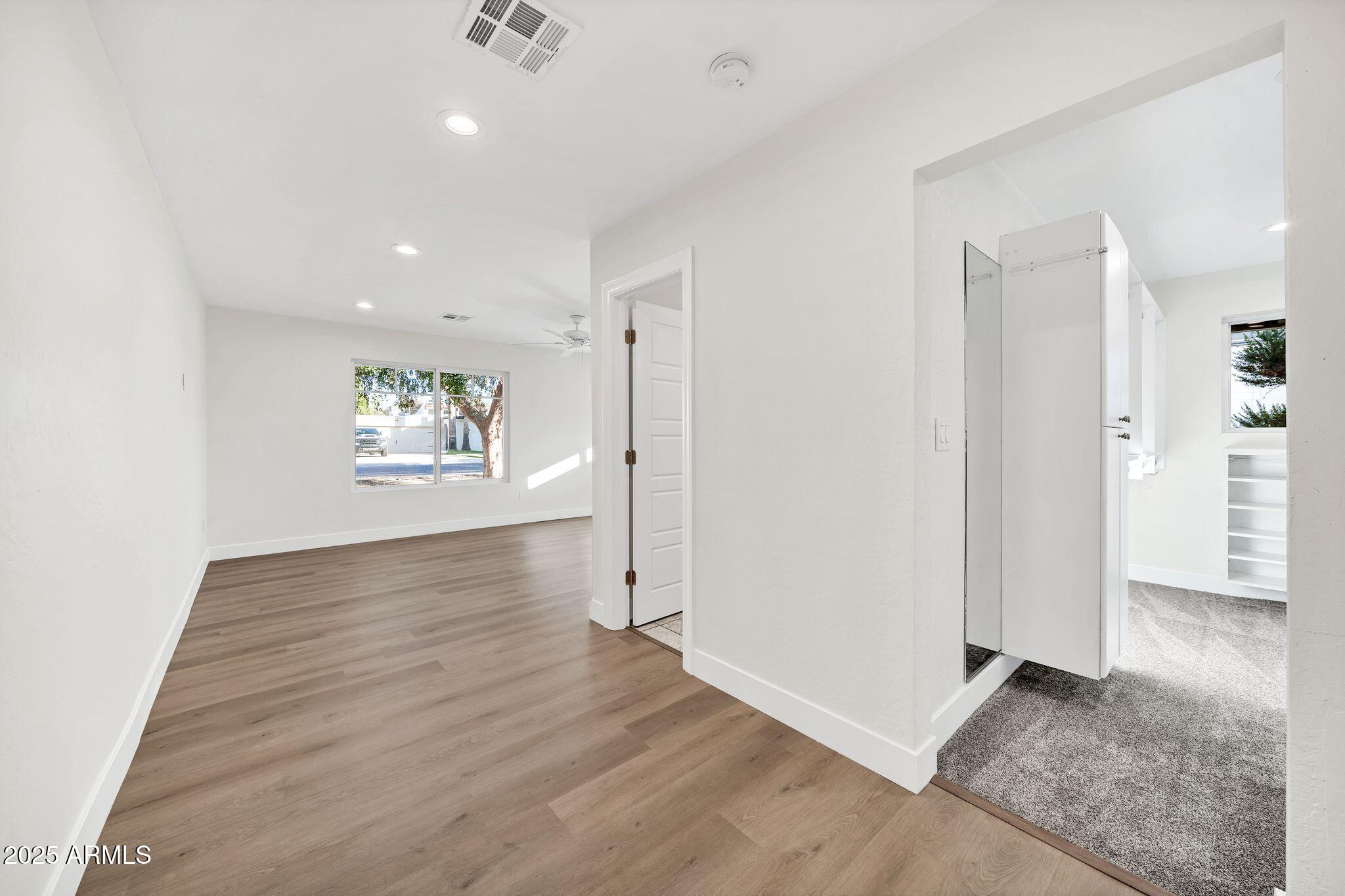 641 West Linger Lane Phoenix, AZ 85021 - Photo 13 of 38 an empty room with wooden floor and windows
