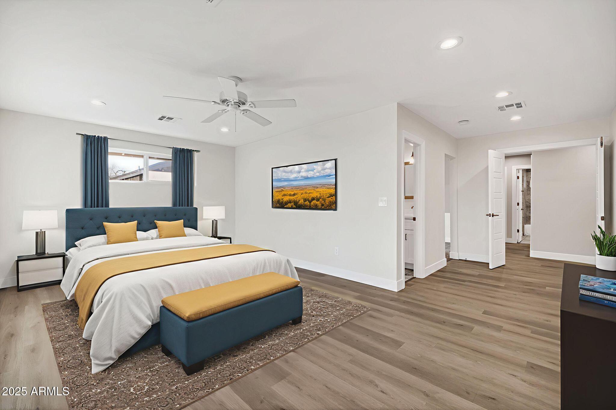 641 West Linger Lane Phoenix, AZ 85021 - Photo 15 of 38 a spacious bedroom with a bed and a ceiling fan