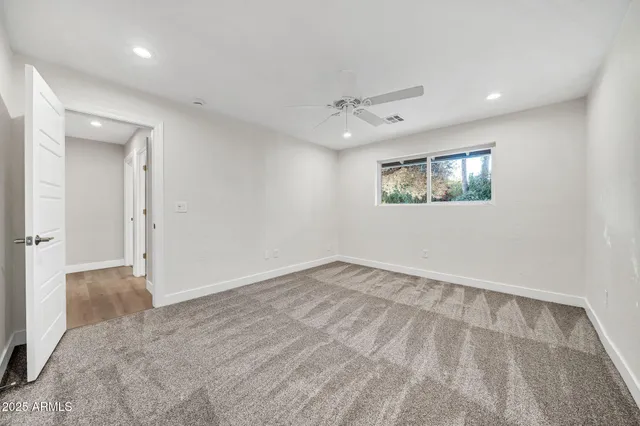 a bathroom with a sink a toilet a mirror and bathtub
