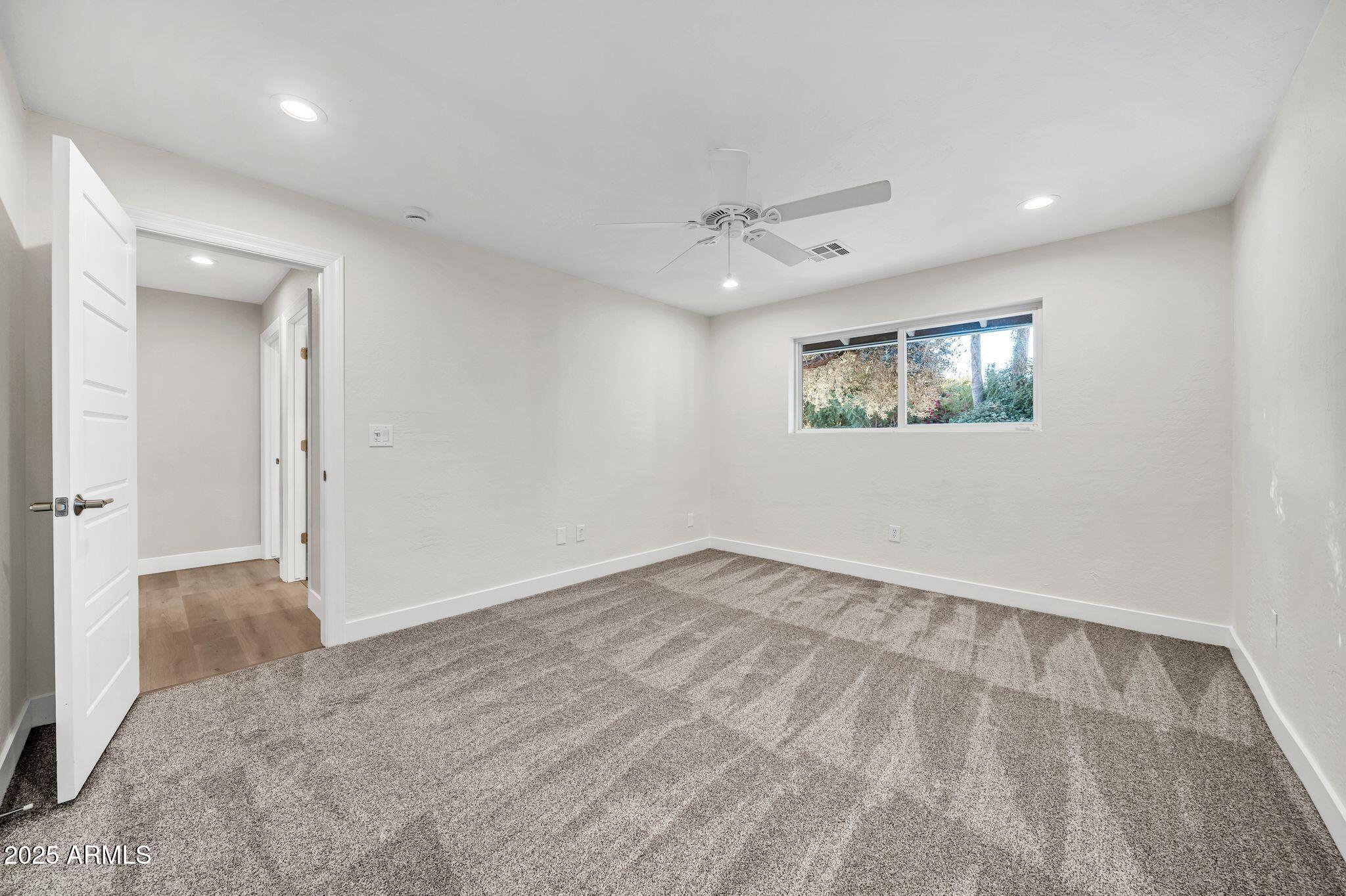 641 West Linger Lane Phoenix, AZ 85021 - Photo 21 of 38 wooden floor in an empty room with a window