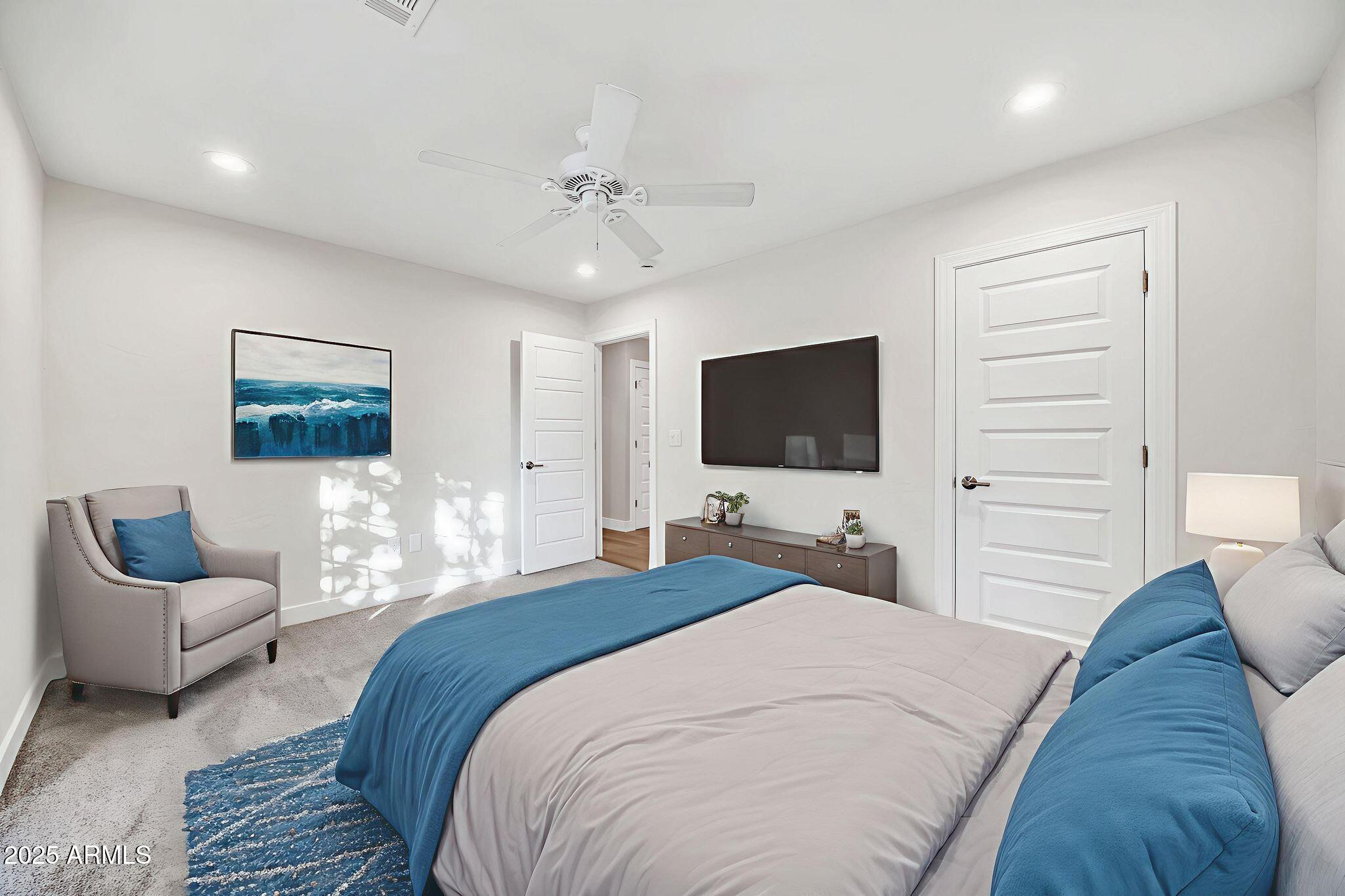 641 West Linger Lane Phoenix, AZ 85021 - Photo 22 of 38 a bedroom with a bed and a flat screen tv