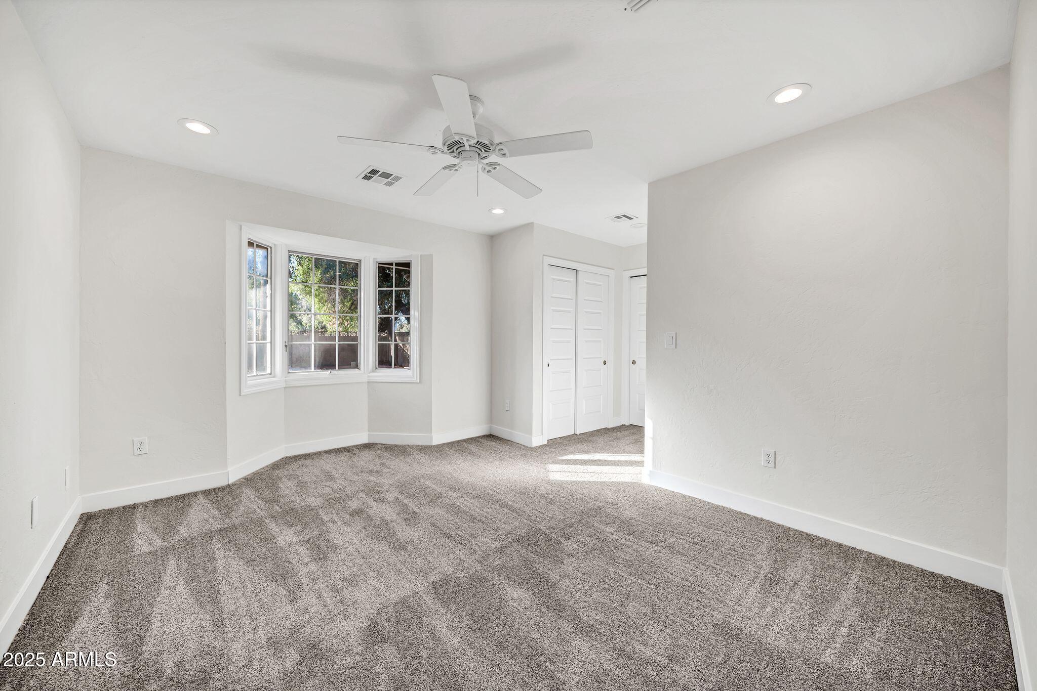 641 West Linger Lane Phoenix, AZ 85021 - Photo 23 of 38 an empty room with windows and fan