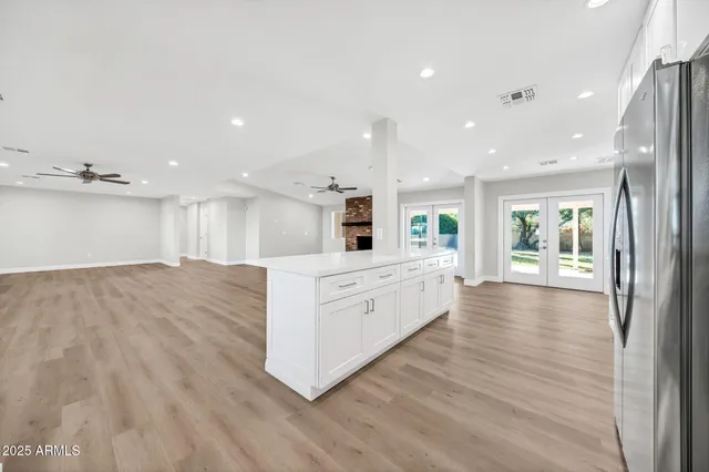 a view of empty room with wooden floor fireplace and windows