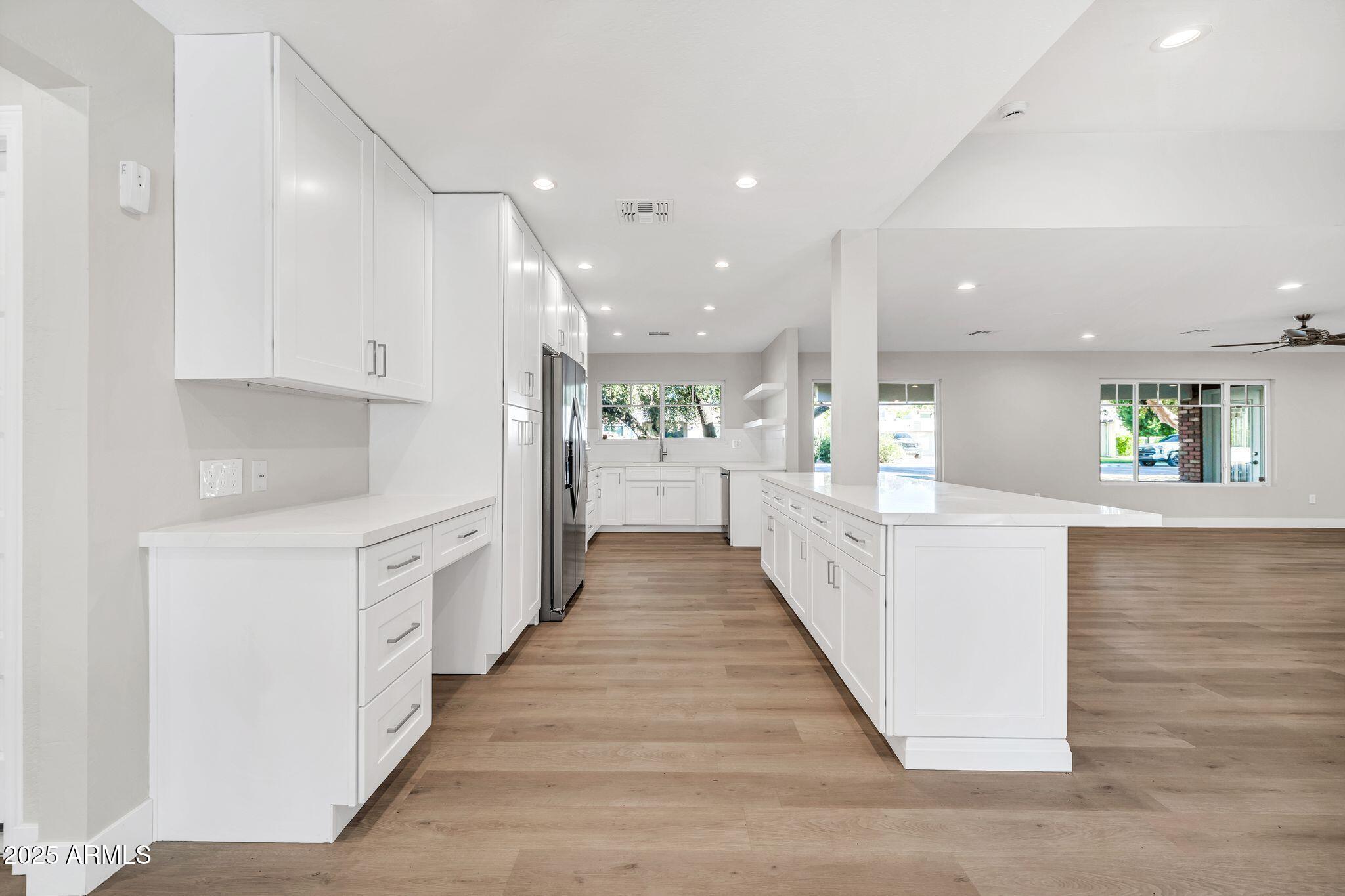 641 West Linger Lane Phoenix, AZ 85021 - Photo 7 of 38 a view of a kitchen with kitchen island wooden floor center island and stainless steel appliances