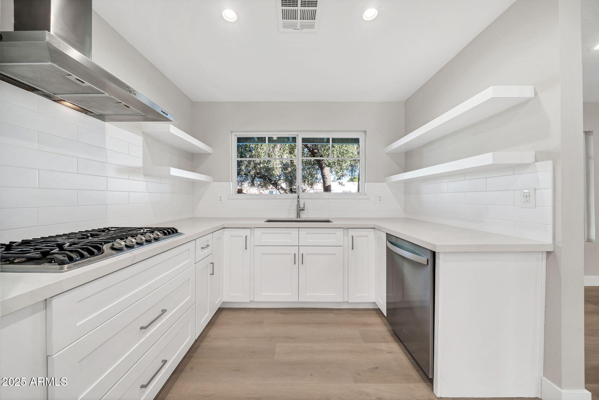 641 West Linger Lane Phoenix, AZ 85021 - Photo 9 of 38 a kitchen with white cabinets and appliances