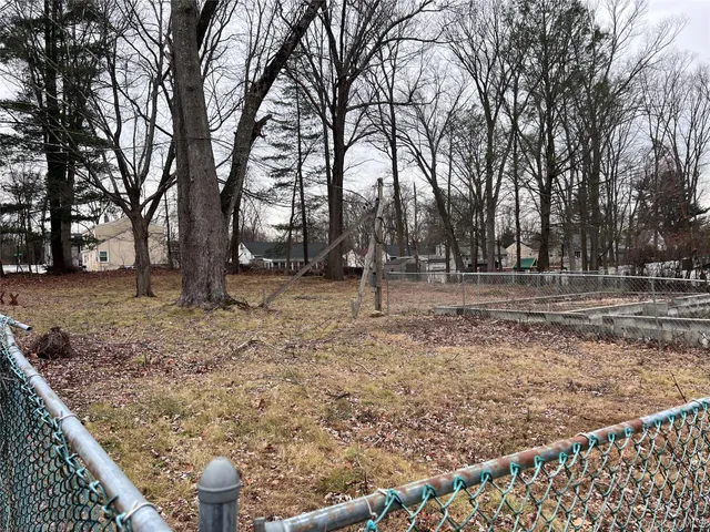 a backyard of a house with lots of trees