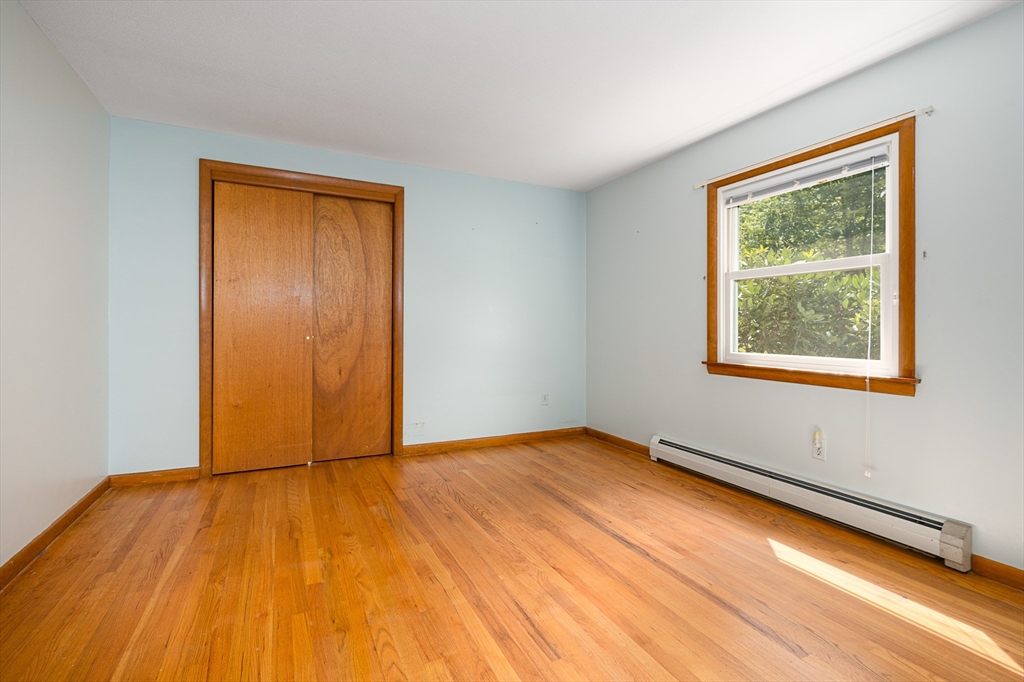 124 Pondview Drive Amherst, MA 01002 - Photo 15 of 35 a view of an empty room with wooden floor and a window