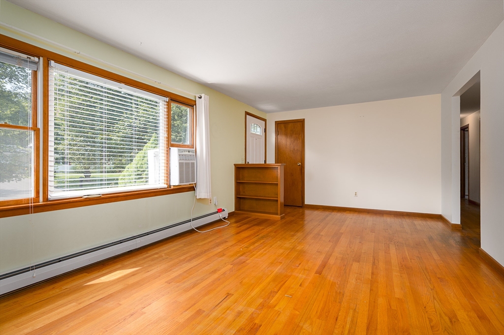 124 Pondview Drive Amherst, MA 01002 - Photo 5 of 35 a view of an empty room with a window and wooden floor