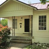 a front view of a house with a garden