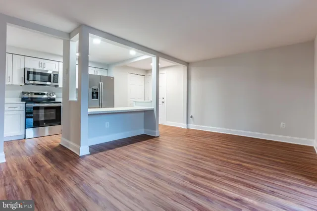 a view of a kitchen with wooden floor and a kitchen