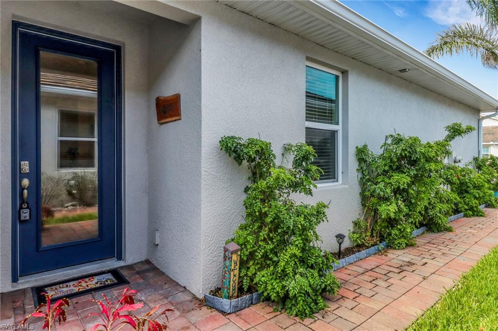 1256 Enbrook Loop Naples, FL 34114 - Photo 2 of 35 a backyard of a house with potted plants