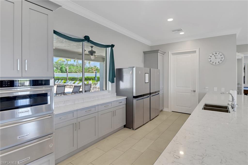 1256 Enbrook Loop Naples, FL 34114 - Photo 26 of 35 a kitchen with refrigerator and window