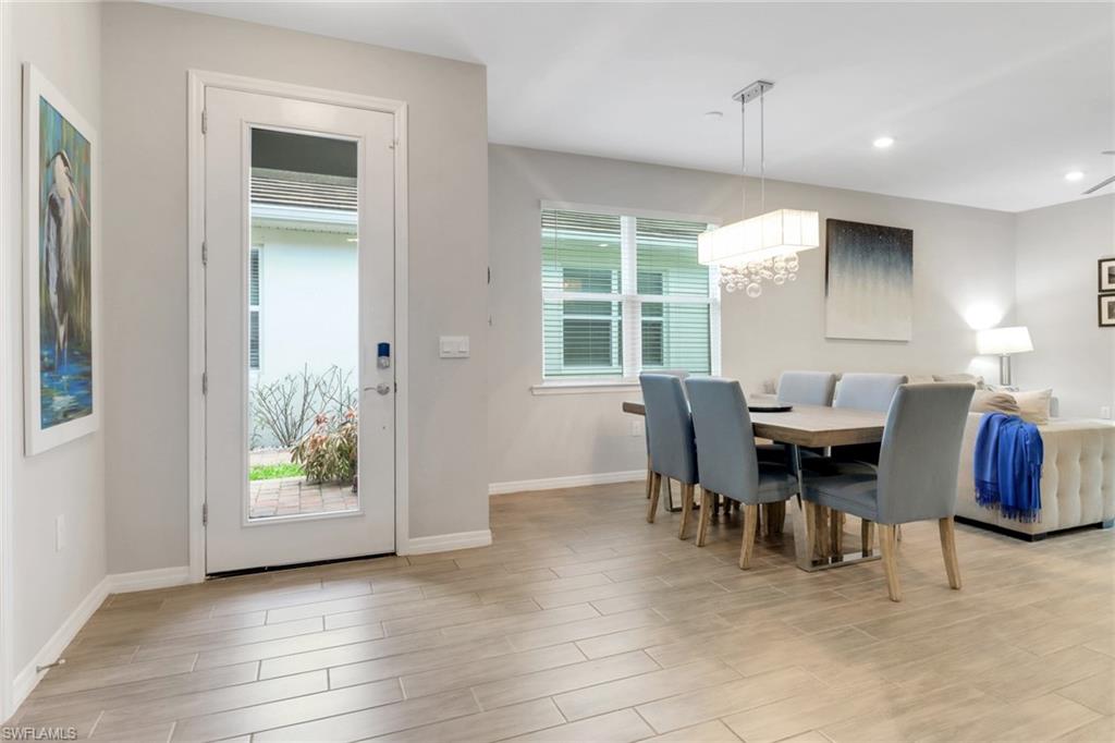 1256 Enbrook Loop Naples, FL 34114 - Photo 3 of 35 a dining room with furniture and window