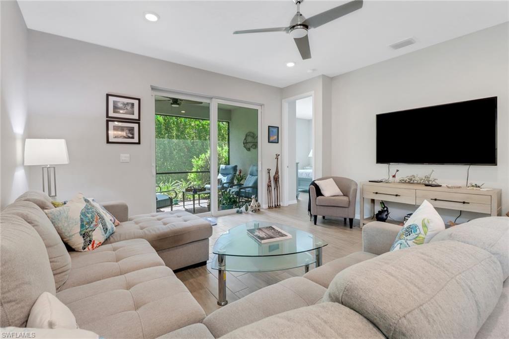 1256 Enbrook Loop Naples, FL 34114 - Photo 6 of 35 a living room with furniture and a flat screen tv