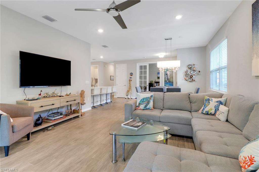 1256 Enbrook Loop Naples, FL 34114 - Photo 7 of 35 a living room with furniture and a flat screen tv
