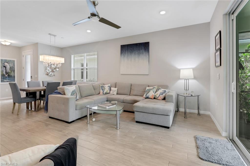 1256 Enbrook Loop Naples, FL 34114 - Photo 8 of 35 a living room with furniture and a lamp