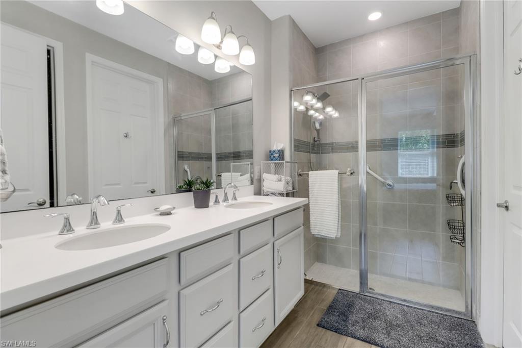 1256 Enbrook Loop Naples, FL 34114 - Photo 9 of 35 a bathroom with a double vanity sink mirror and shower