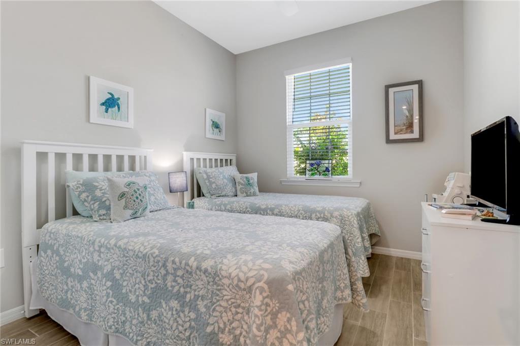 1256 Enbrook Loop Naples, FL 34114 - Photo 10 of 35 a bedroom with a bed and a flat screen tv