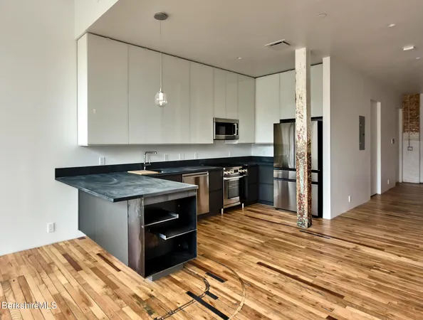 a kitchen with a stove and a refrigerator