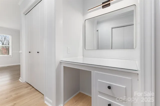 a bathroom with a bathtub sink vanity and mirror