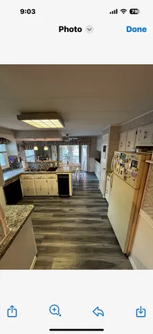 a view of kitchen with stove and refrigerator