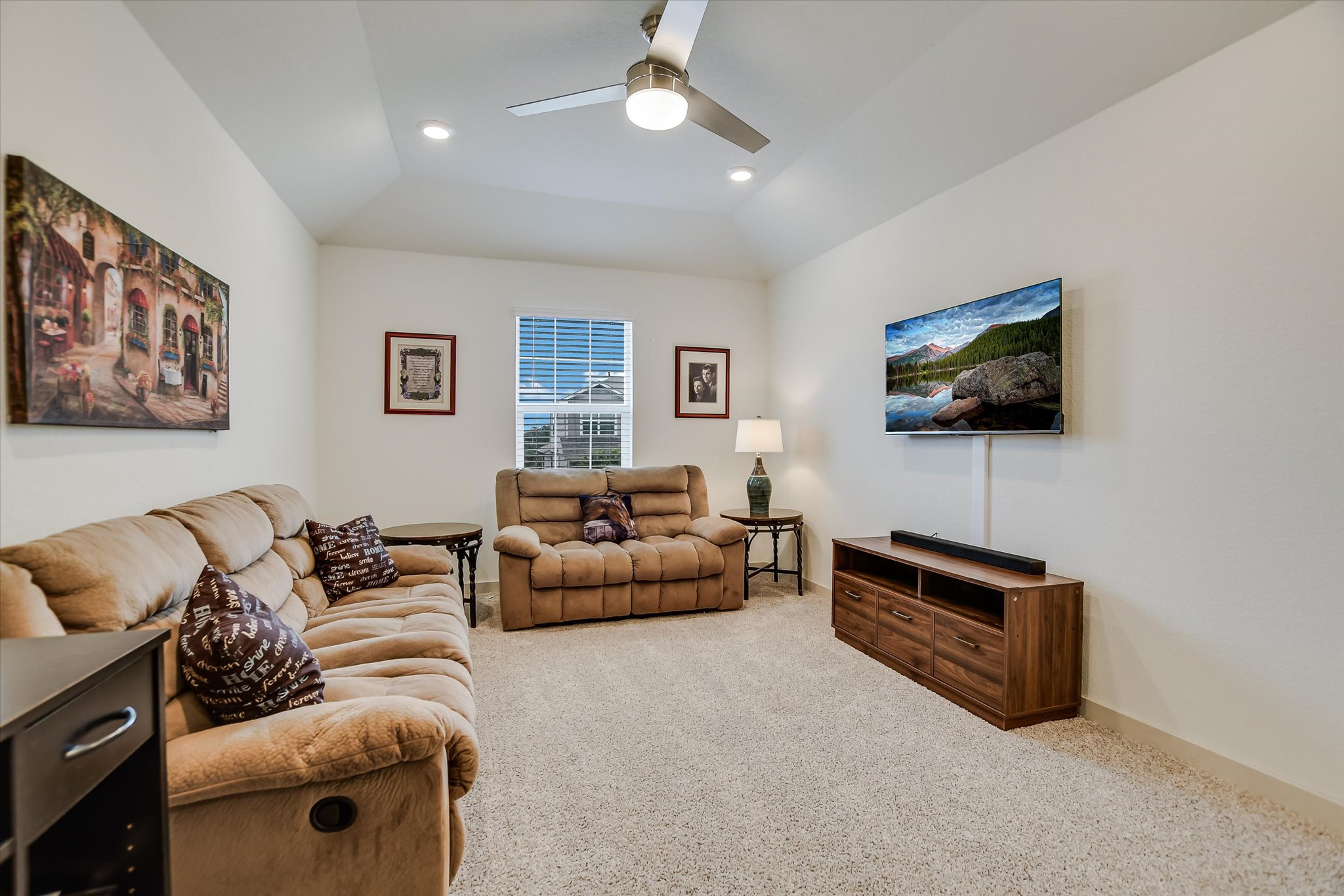 105 Merrick Road Georgetown, TX 78628 - Photo 8 of 23 A comfortable living area with vaulted ceilings offers a cozy retreat.