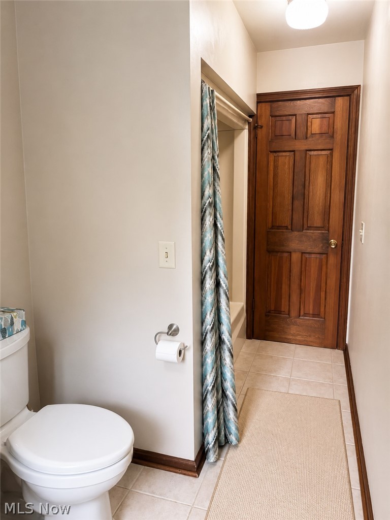 6155 Gibson Road Canfield, OH 44406 - Photo 35 of 43 Bathroom with a white toilet, light-colored tile flooring, and a shower area featuring a white tub surround