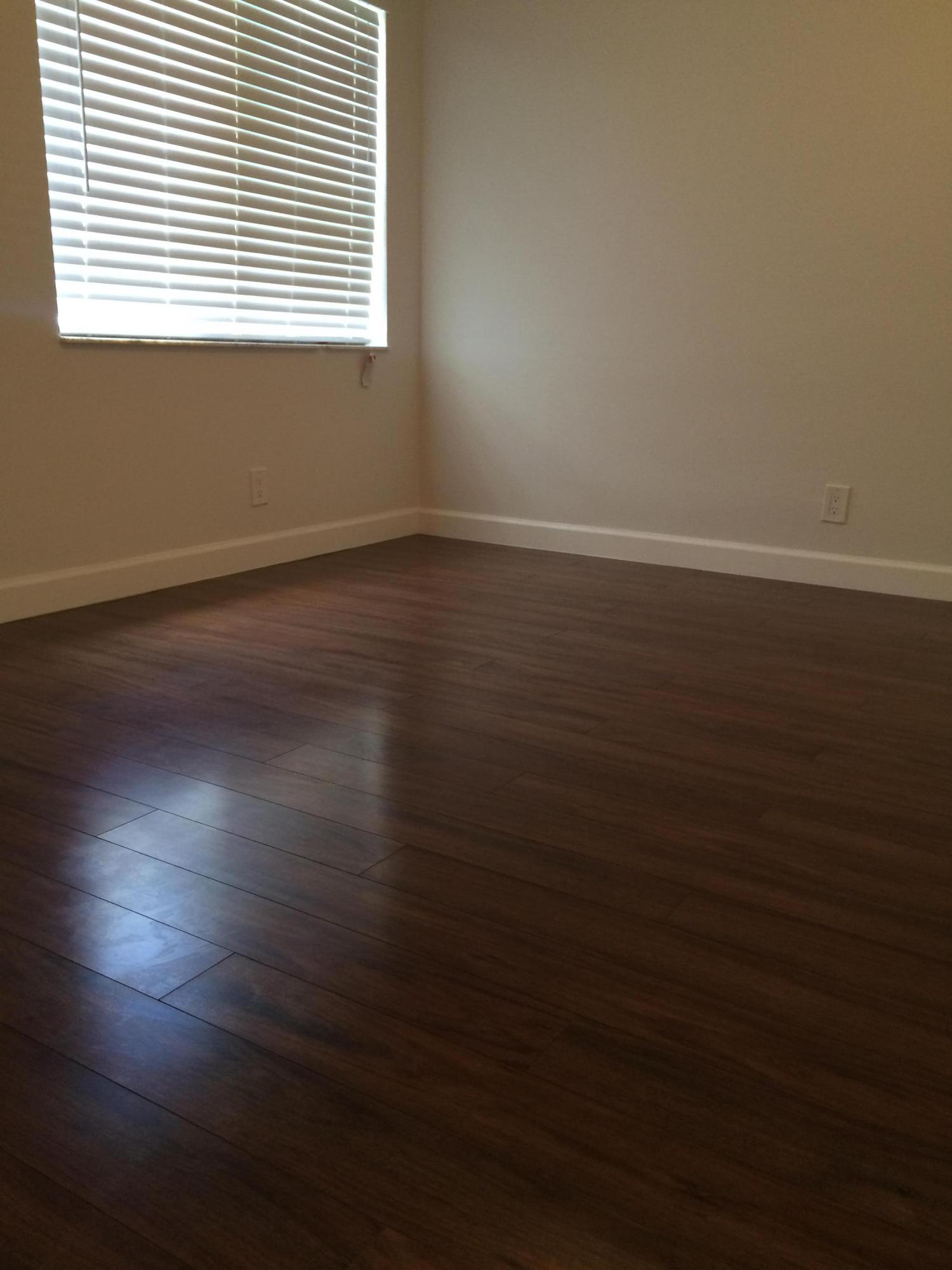 21580 Magdalena Terrace Boca Raton, FL 33433 - Photo 17 of 32 an empty room with wooden floor and windows