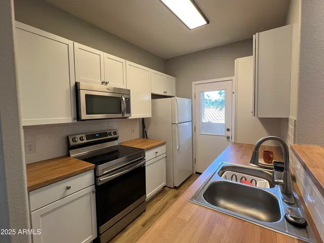 a kitchen with a stove a sink and a microwave
