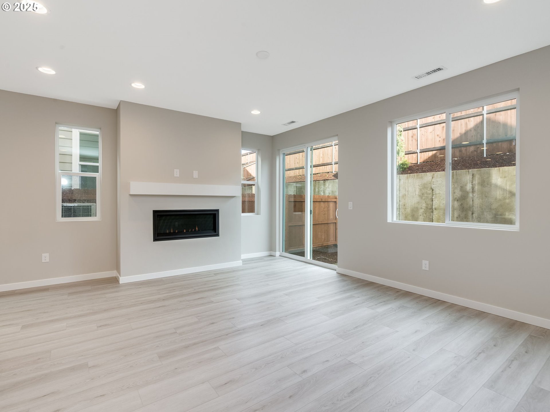 712 Northwest 178th Street Ridgefield, WA 98642 - Photo 8 of 41 a view of an empty room with wooden floor and a window