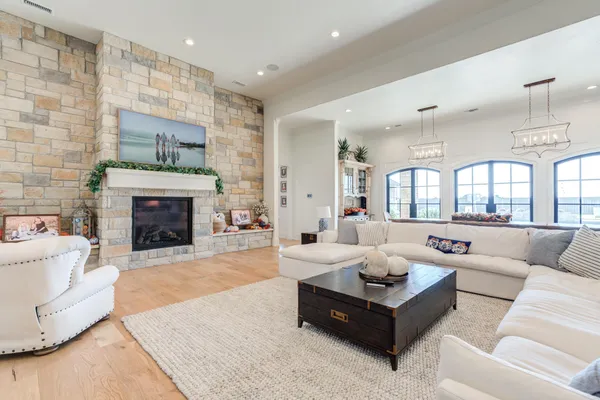a living room with furniture a rug and white walls