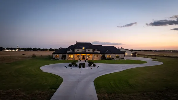 a house view with swimming pool in front of it