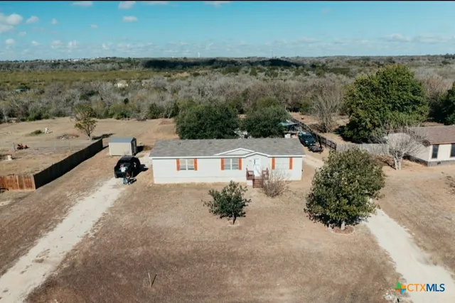 an aerial view of a house with a lake view