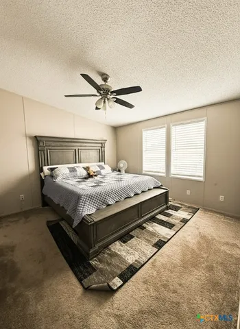 a bedroom with a bed a window and closet