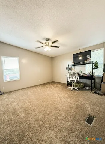 a view of a room with gym equipment and a window