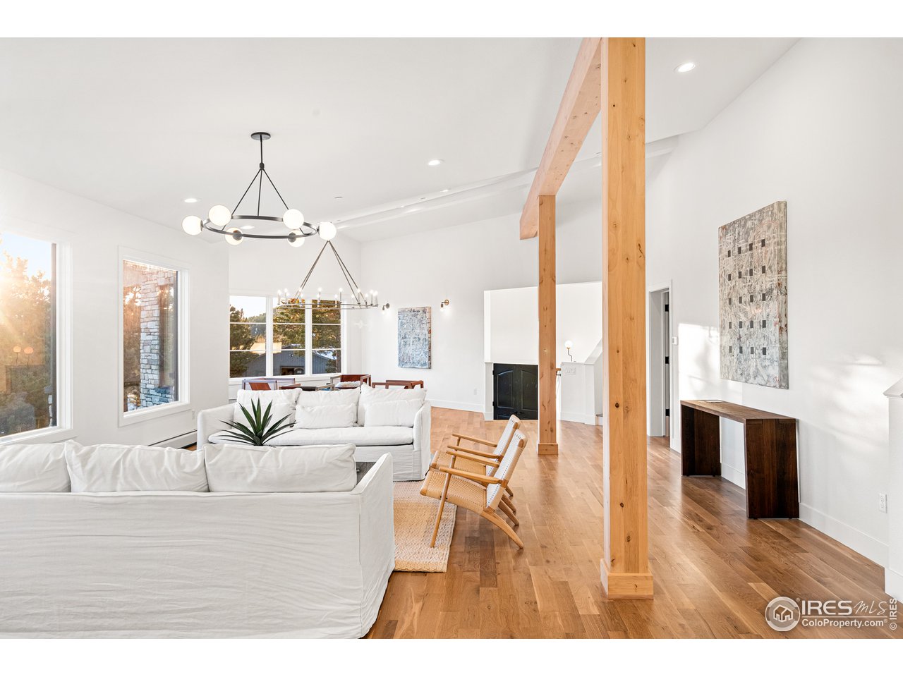 4872 Sugarloaf Road Boulder, CO 80302 - Photo 10 of 40 a living room with furniture dining table and a fireplace