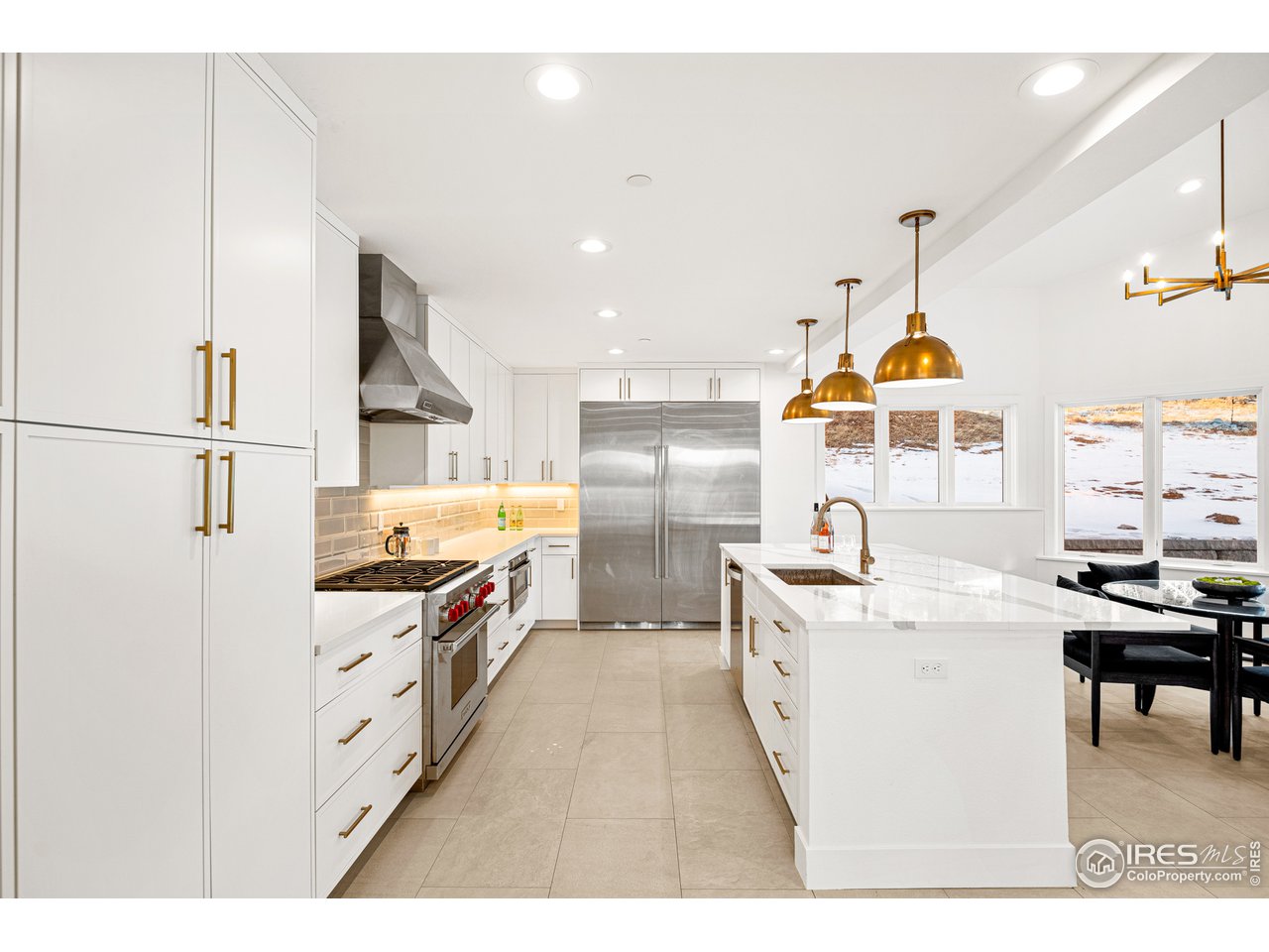 4872 Sugarloaf Road Boulder, CO 80302 - Photo 16 of 40 a kitchen with stainless steel appliances a stove a sink dishwasher and a refrigerator