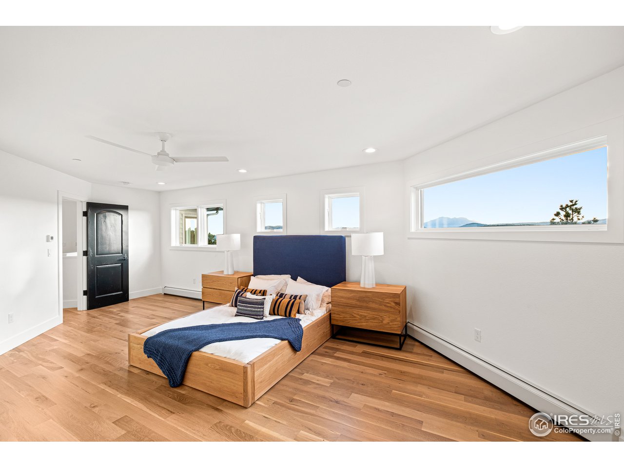4872 Sugarloaf Road Boulder, CO 80302 - Photo 18 of 40 a bedroom with furniture and wooden floor