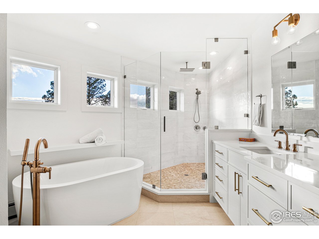 4872 Sugarloaf Road Boulder, CO 80302 - Photo 19 of 40 a bathroom with a double vanity sink a mirror a bathtub and shower