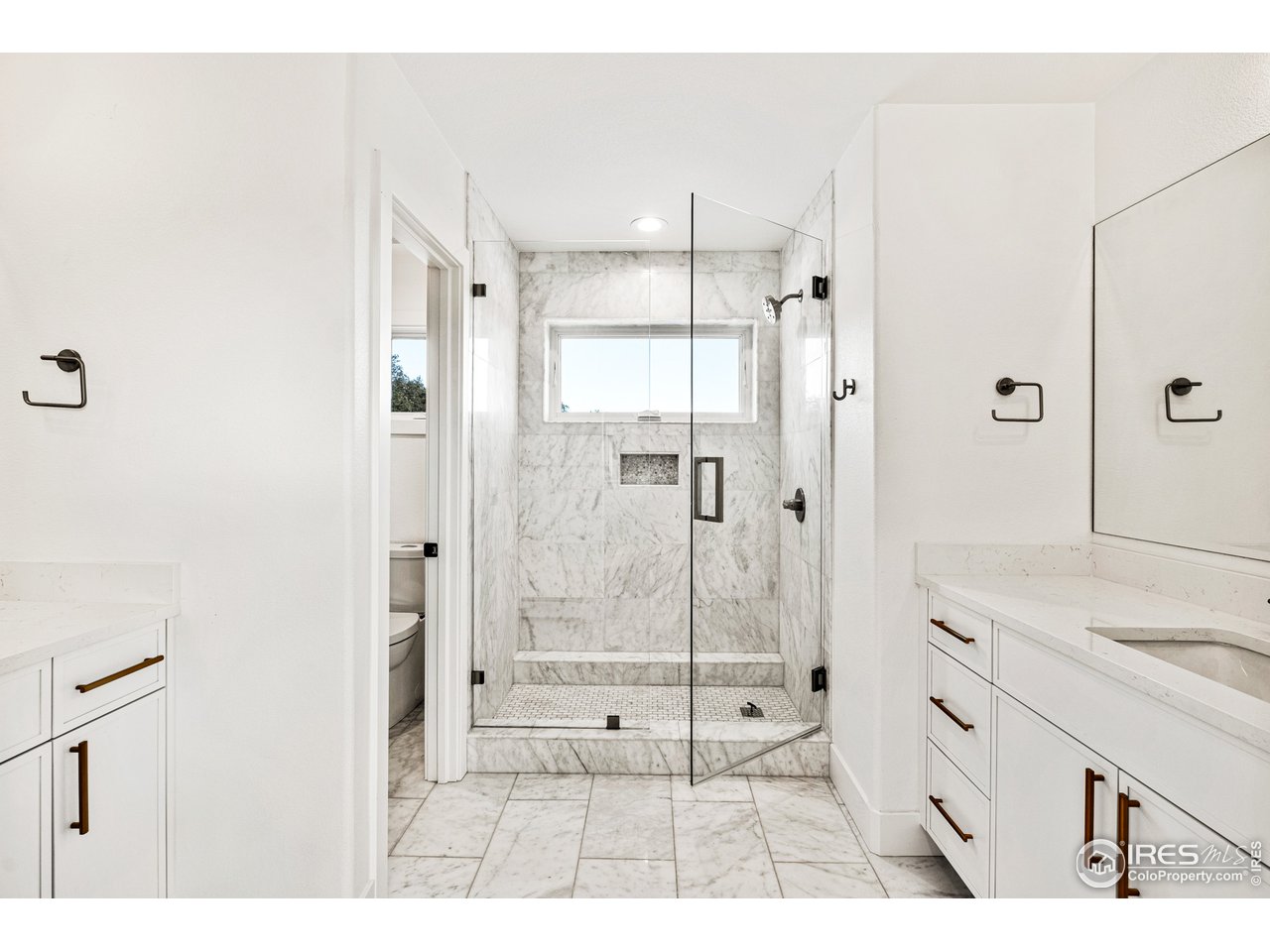 4872 Sugarloaf Road Boulder, CO 80302 - Photo 23 of 40 a bathroom with a shower sink and mirror