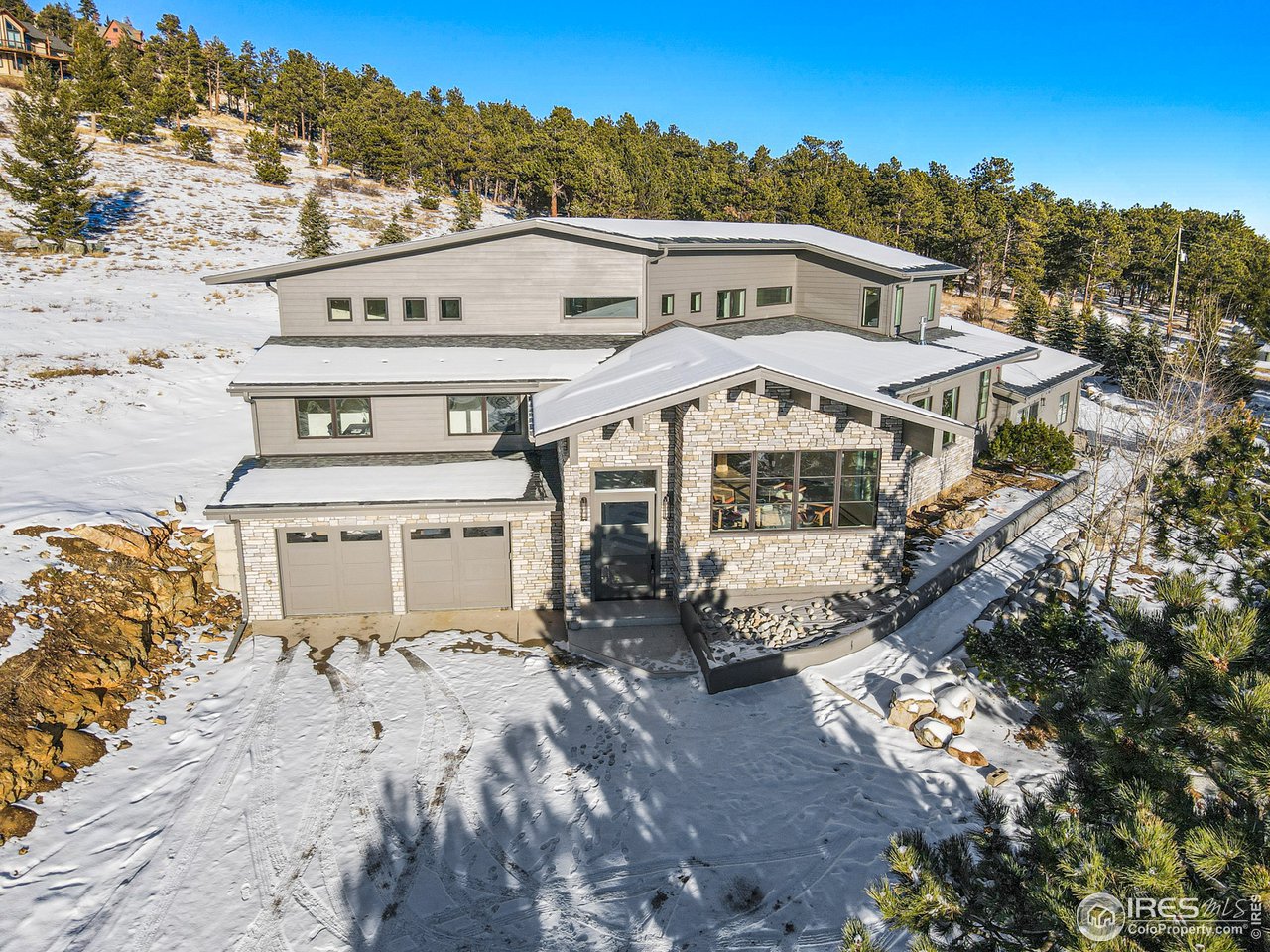 4872 Sugarloaf Road Boulder, CO 80302 - Photo 37 of 40 a view of a white building among the street and trees